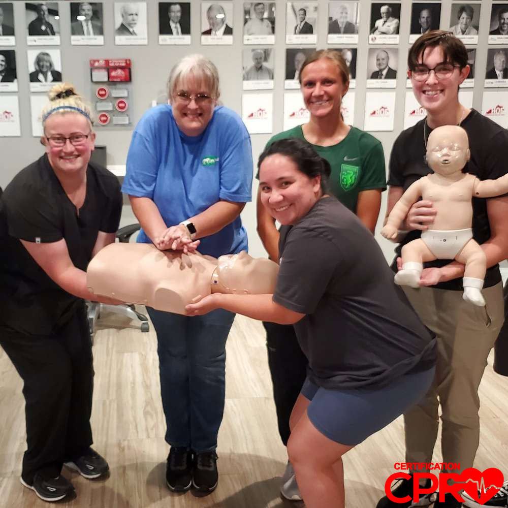 CPR training class in Durham with students practicing on mannequins.